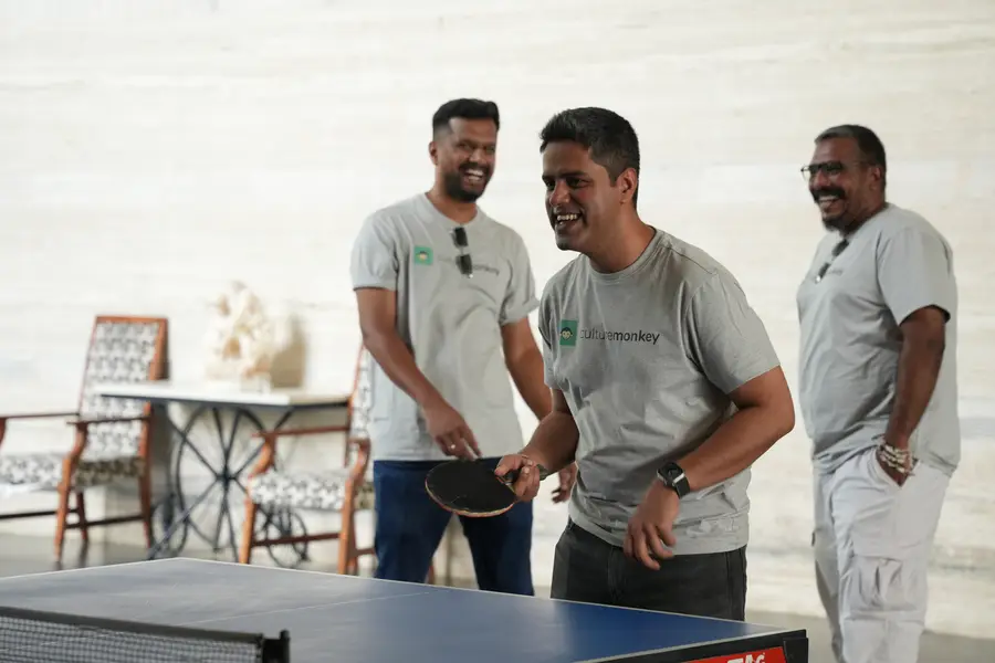 Team members playing table tennis at the retreat